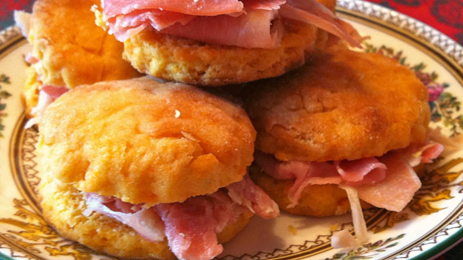 Close up view of ham biscuit sandwiches on a plate