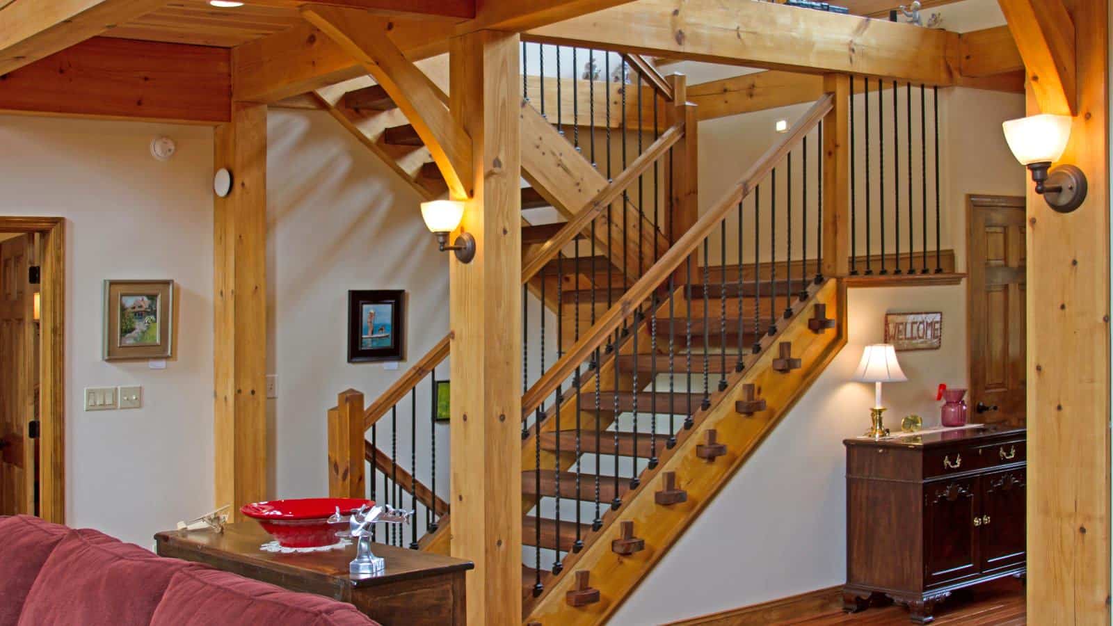 Great room with a staircase made of wood and wrought iron that goes up and down